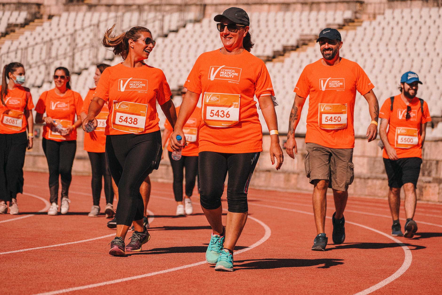 people walking on track and field