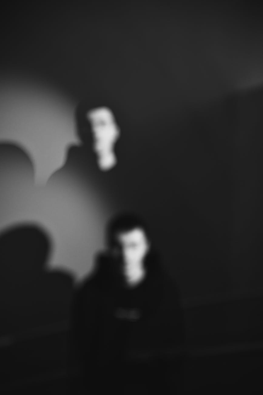man head duplicated in darkness