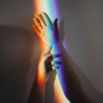 persons hands with rainbow colors